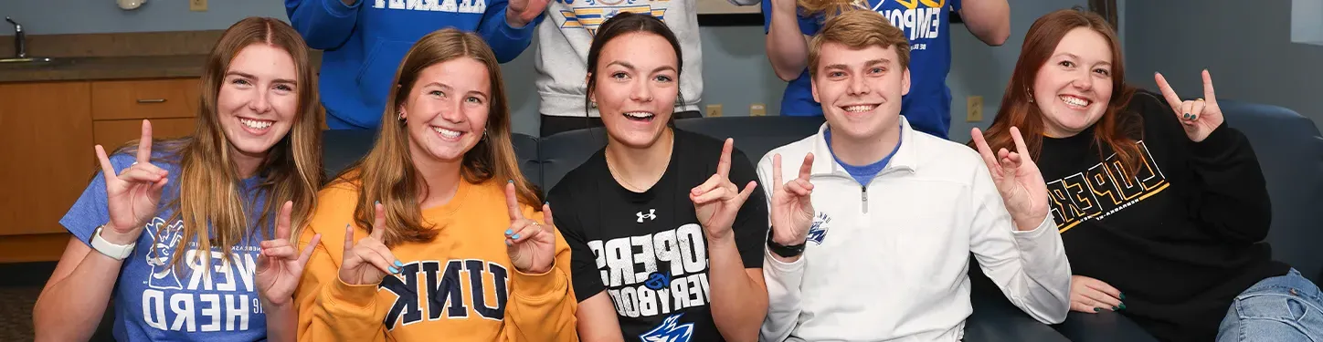 students pose together on a couch